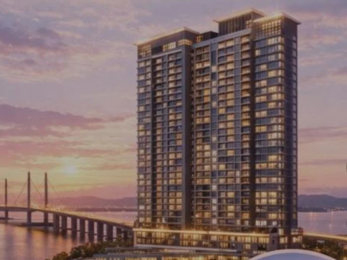 Luxury high-rise condominium beside Penang Bridge at sunset