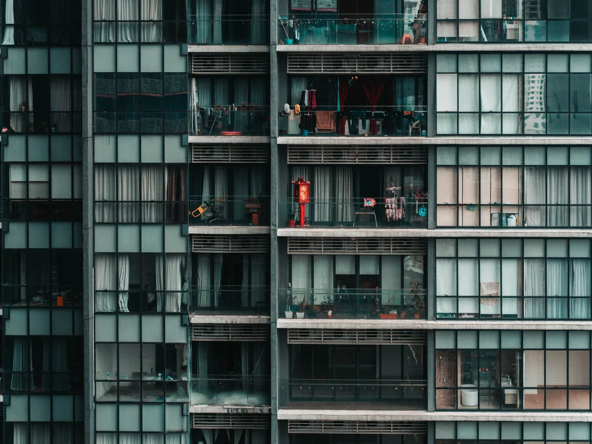 Contemporary apartment block with balconies and glazed facade