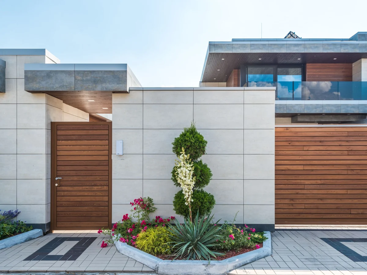 Two-storey house with a timber facade and covered entrance